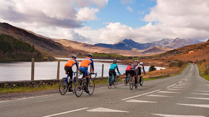 Group cycling on Welsh mountain road