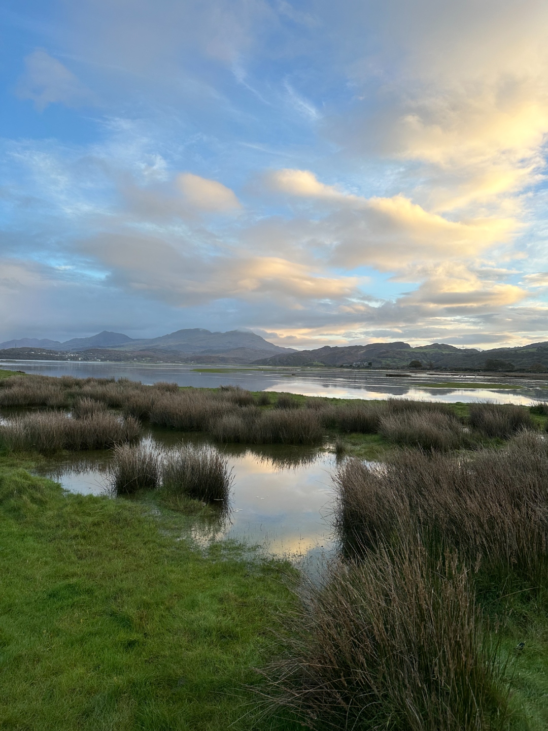 Marshland and estuary with dramatic sunset clouds