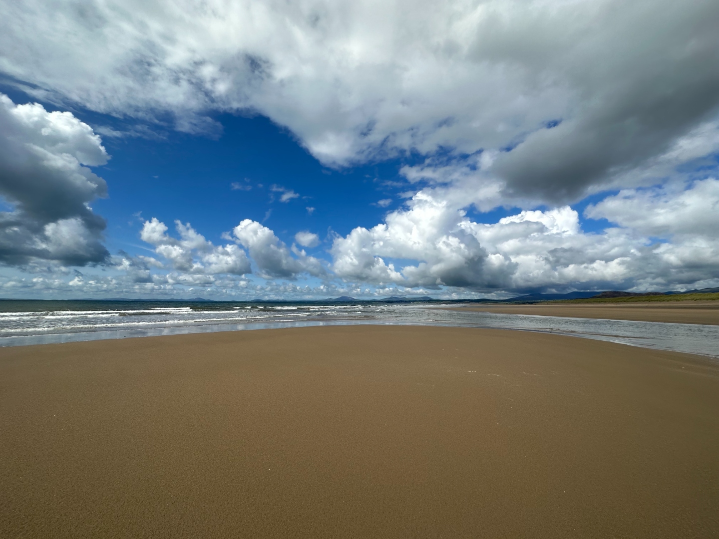 Wide panoramic beach with dramatic clouds