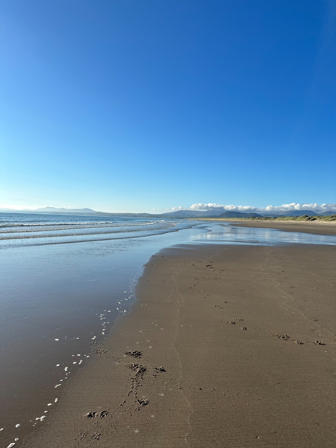 Pristine golden sands stretching into the distance at Harlech